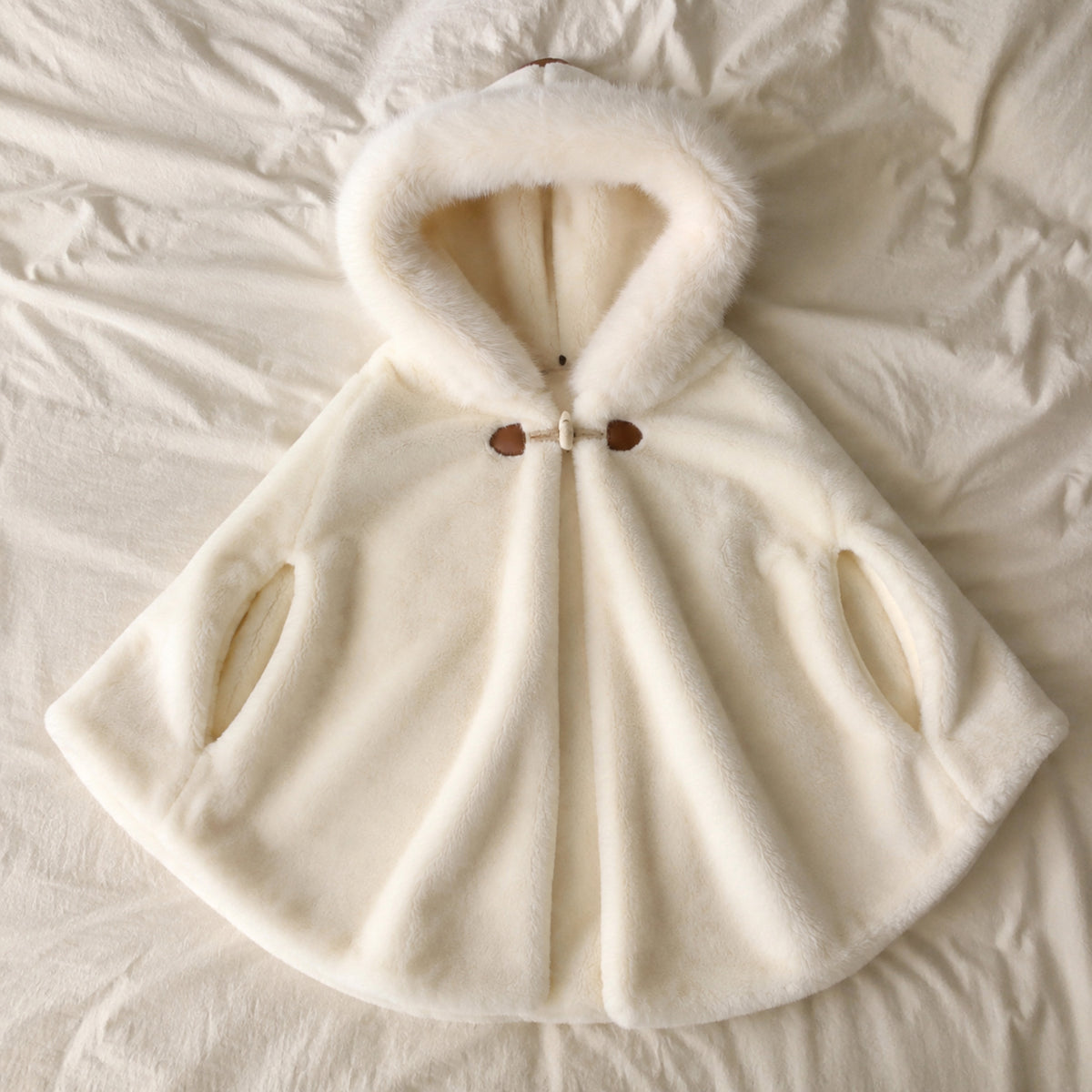 Milky ivory hooded baby cape flat lay