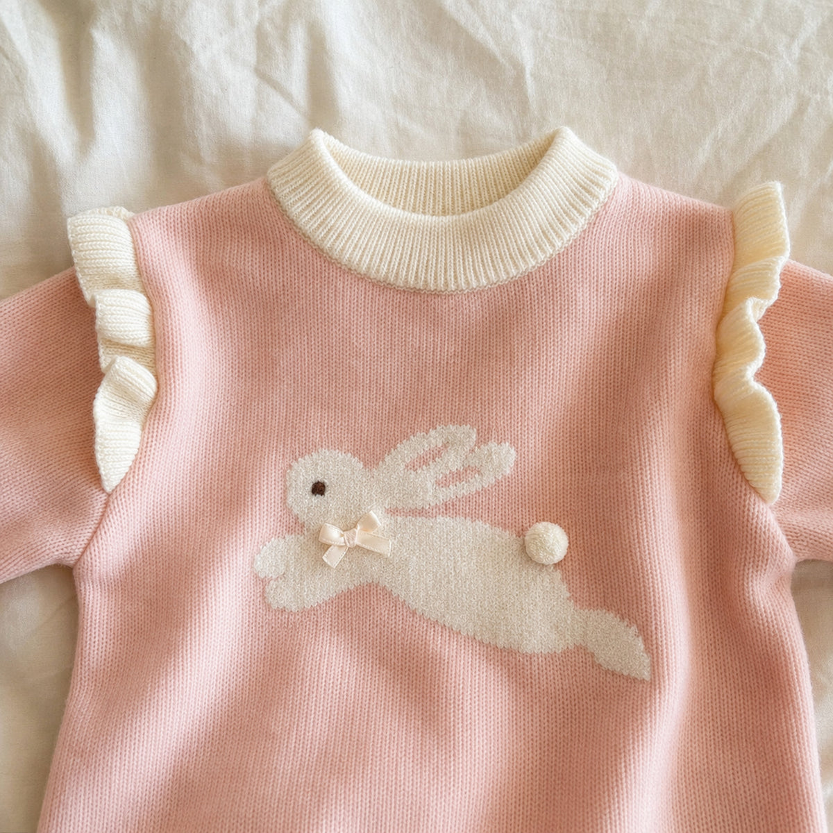 Pink pullover bunny applique and pom tail detail
