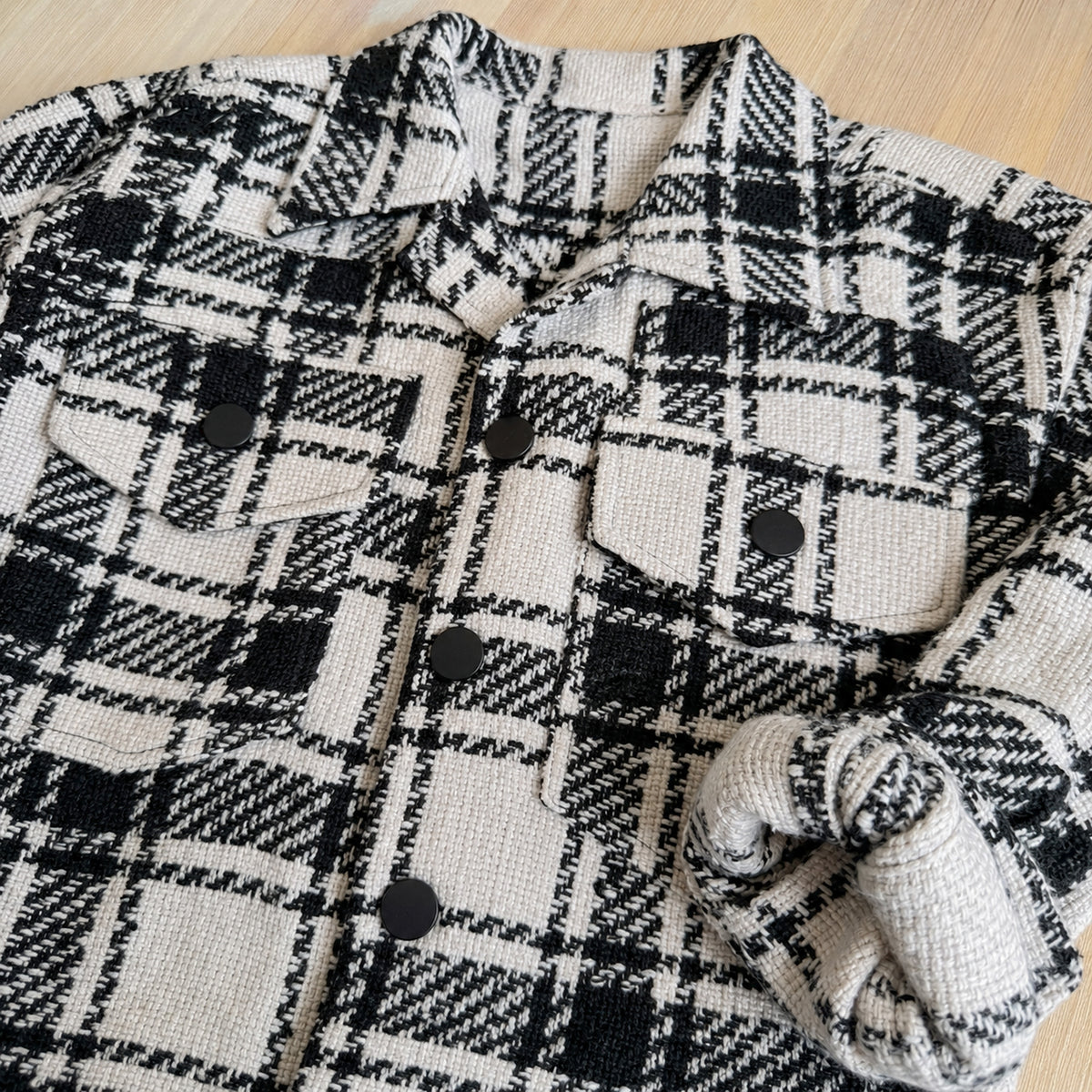 Close detail of plaid shacket collar, buttons and pockets