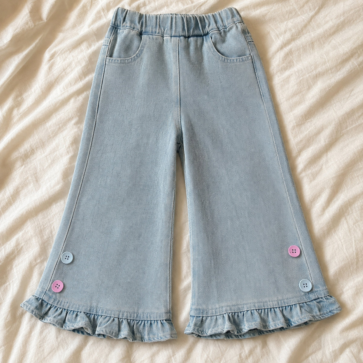 Light blue wide-leg denim pants with ruffled hems flat lay