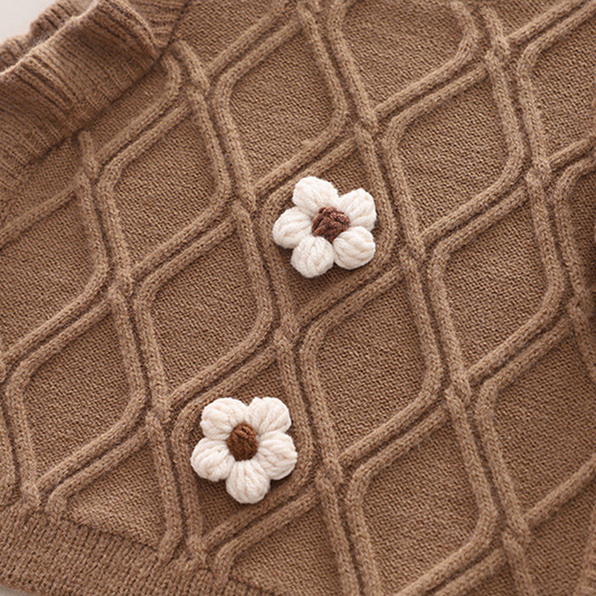 Real close detail of coffee cable knit and crochet flowers