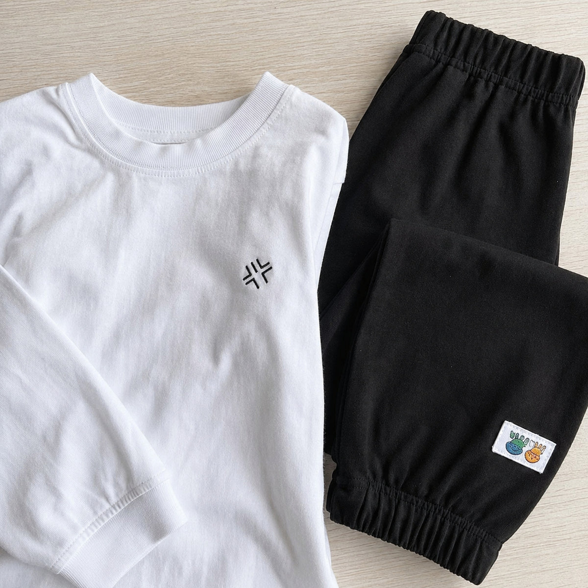 White tee and black jogger pants fabric detail